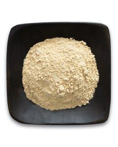 A black plate topped with a pile of powder on a white background.