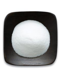 A black square bowl filled with white powder on a white background.