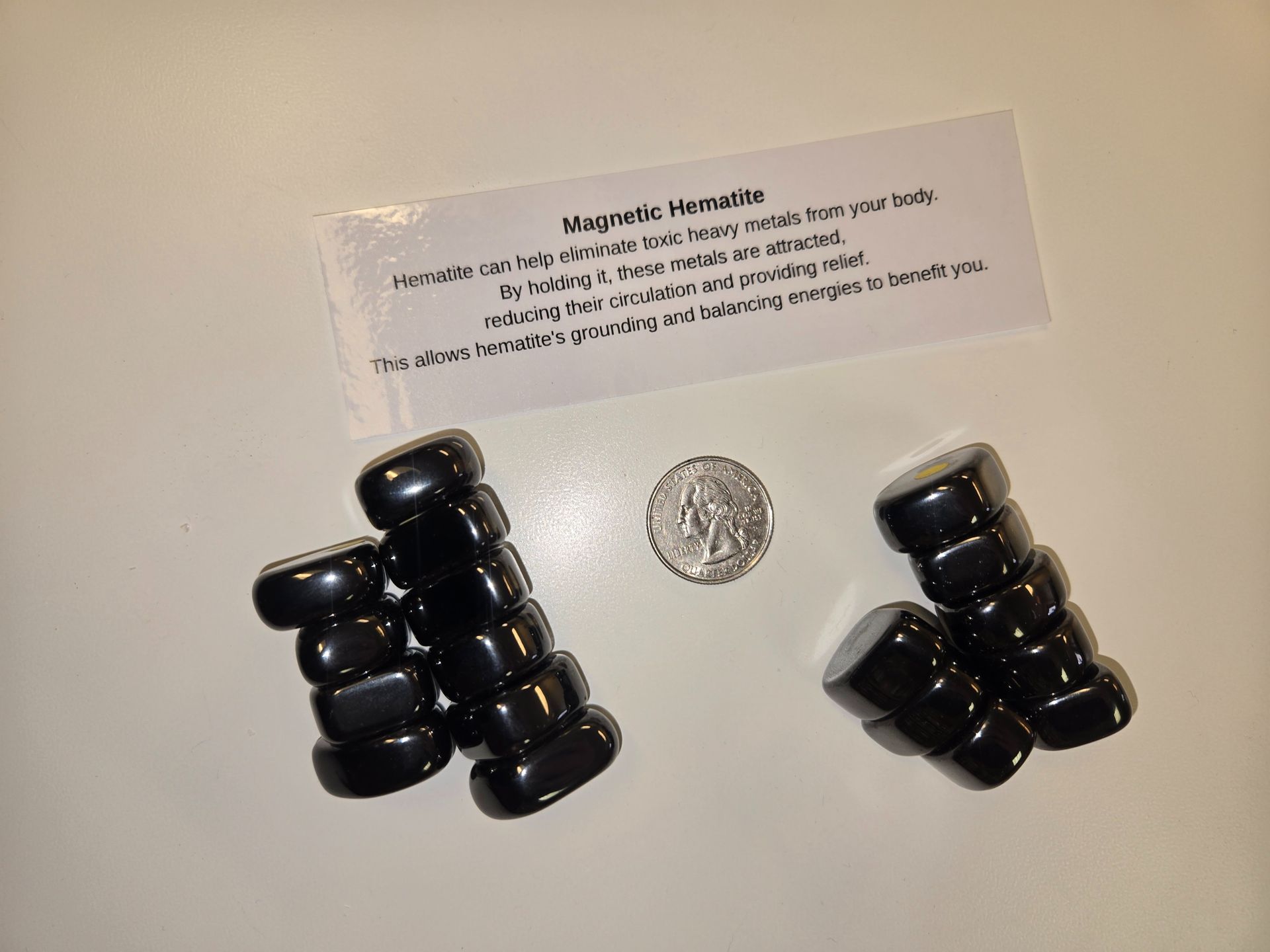 A stack of black beads next to a small coin