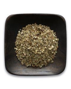 A wooden bowl filled with dried herbs on a white background.