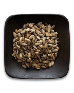 A wooden bowl filled with nuts on a white background.