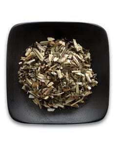 A black bowl filled with dried herbs on a white background.