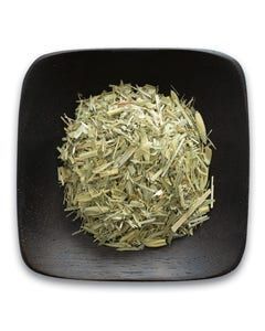A black bowl filled with dried herbs on a white background.