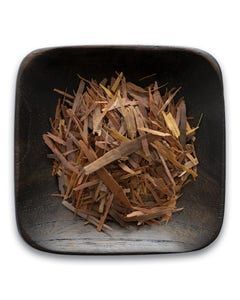 A wooden bowl filled with wood chips on a white background.