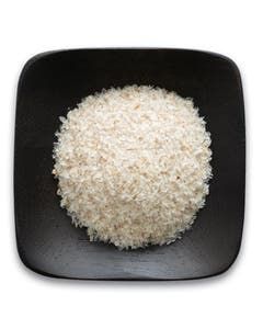 A black square plate topped with rice on a white background.