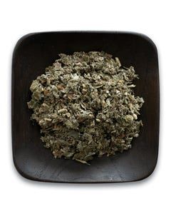 A wooden bowl filled with dried herbs on a white background.