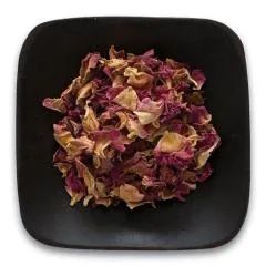 A black square plate topped with dried rose petals on a white background.
