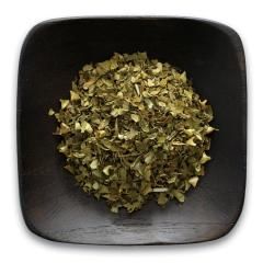 A black bowl filled with dried herbs on a white background.