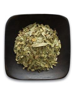 A black bowl filled with dried herbs on a white background.