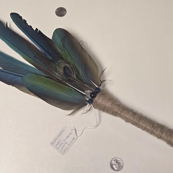 A feather fan with a tag that says ' feathers ' on it