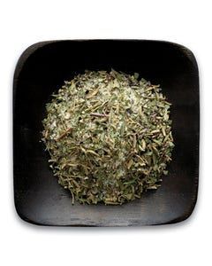 A black bowl filled with dried herbs on a white background.