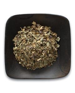A black bowl filled with dried herbs on a white background.