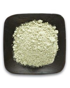 A wooden bowl filled with white powder on a white background.