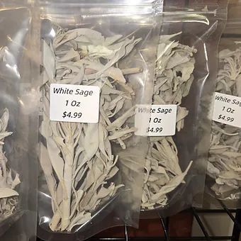 A bunch of bags of white sage are sitting on a table.