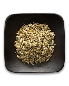A wooden bowl filled with grains on a white background.