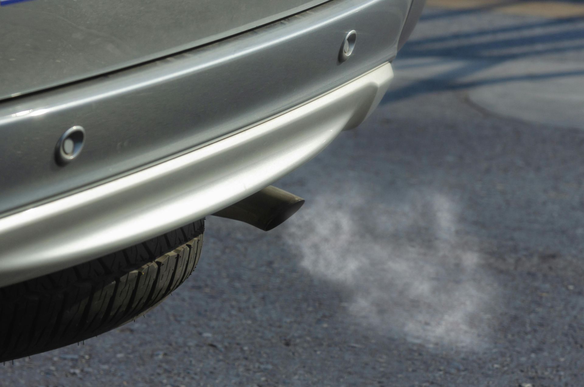 Smoke is coming out of the exhaust pipe of a car