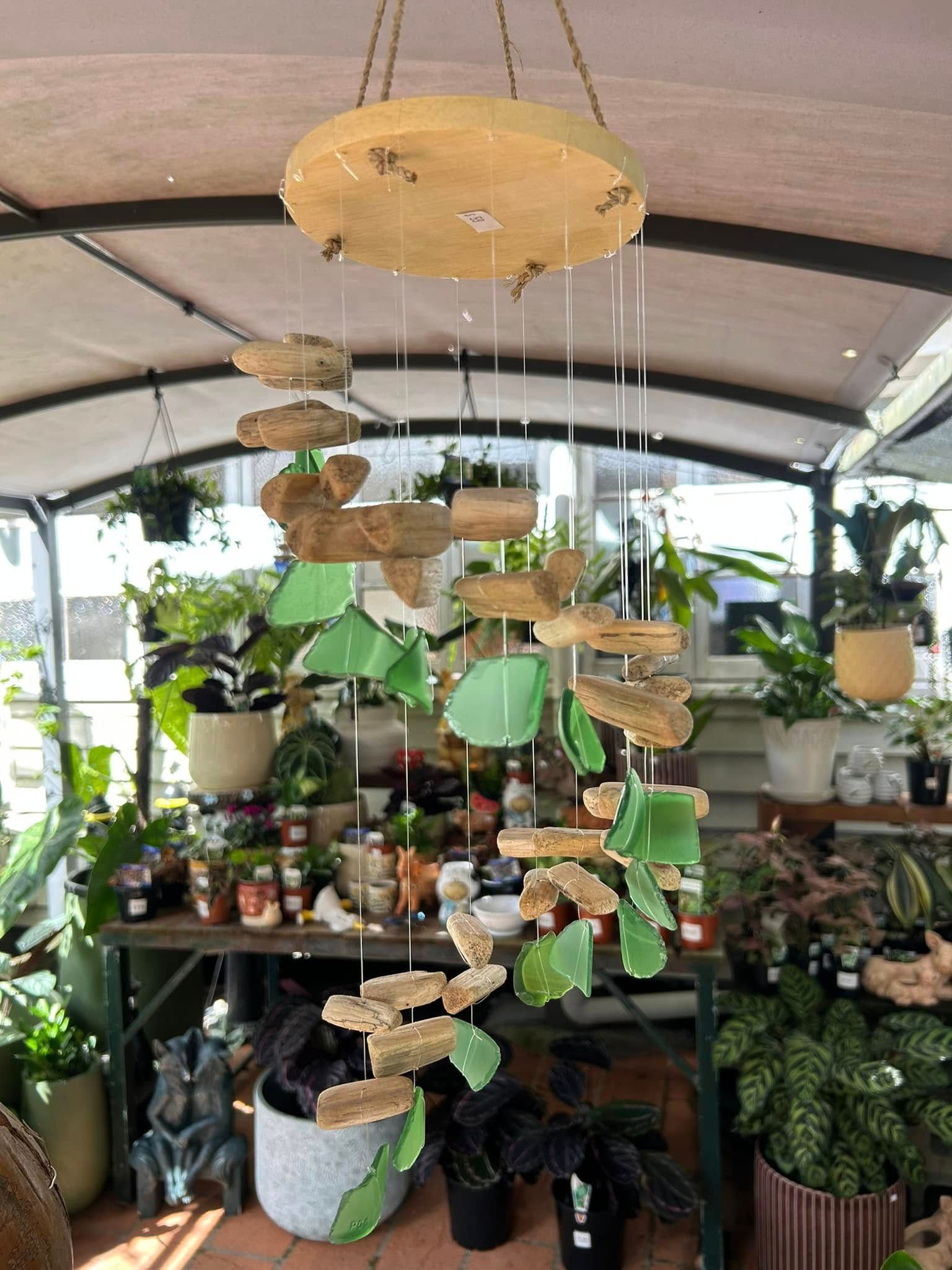 A Hanging Mobile With Wooden and Green Glass Pieces in a Plant Shop — Hinterland Foliage in Landsborough, QLD