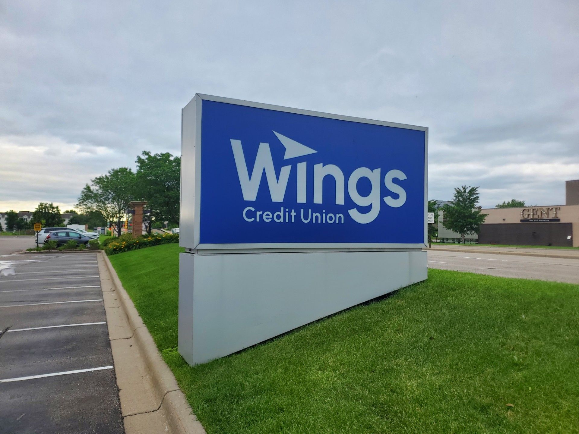 Franklin Middle School sign above a drained pool; worker on lift, white, blue. Franklin Middle School sign above a drained pool; worker on lift, white, blue.