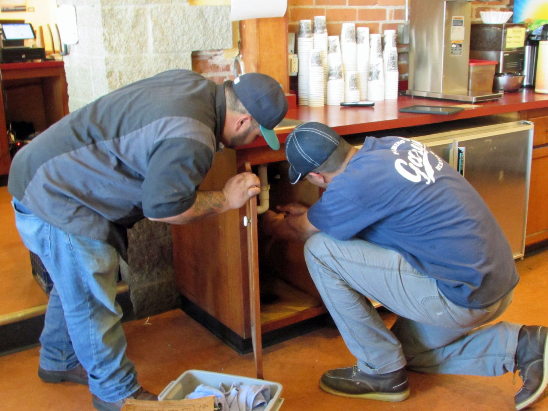 A man in a blue shirt with the letter g on it