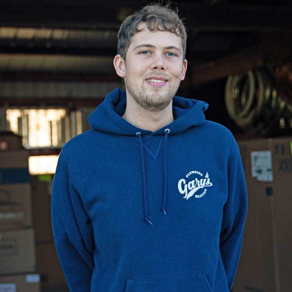 A man wearing a blue hoodie with the word garage on it