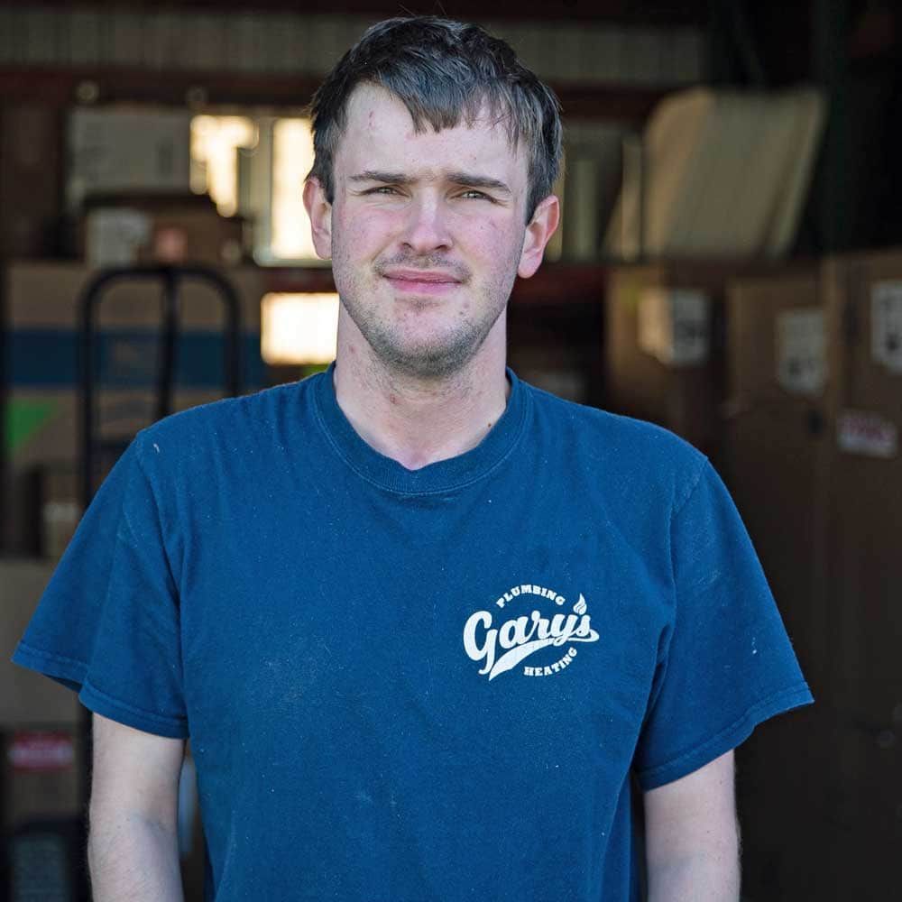 A man wearing a blue shirt that says ' gail ' on it