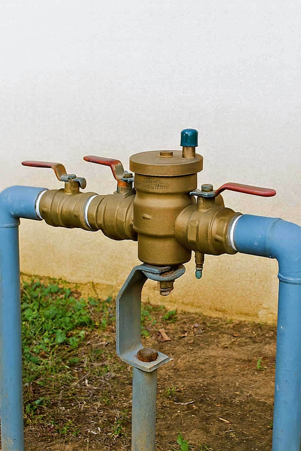 Backflow prevention valve assembly on outdoor pipes.