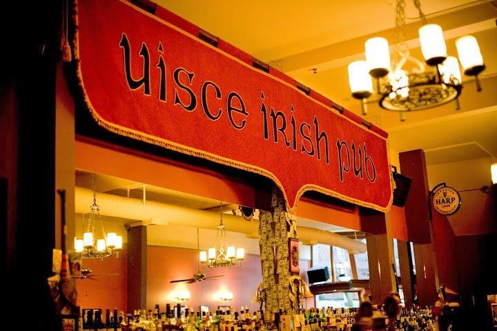 A restaurant with a sign that says uisce irish pub