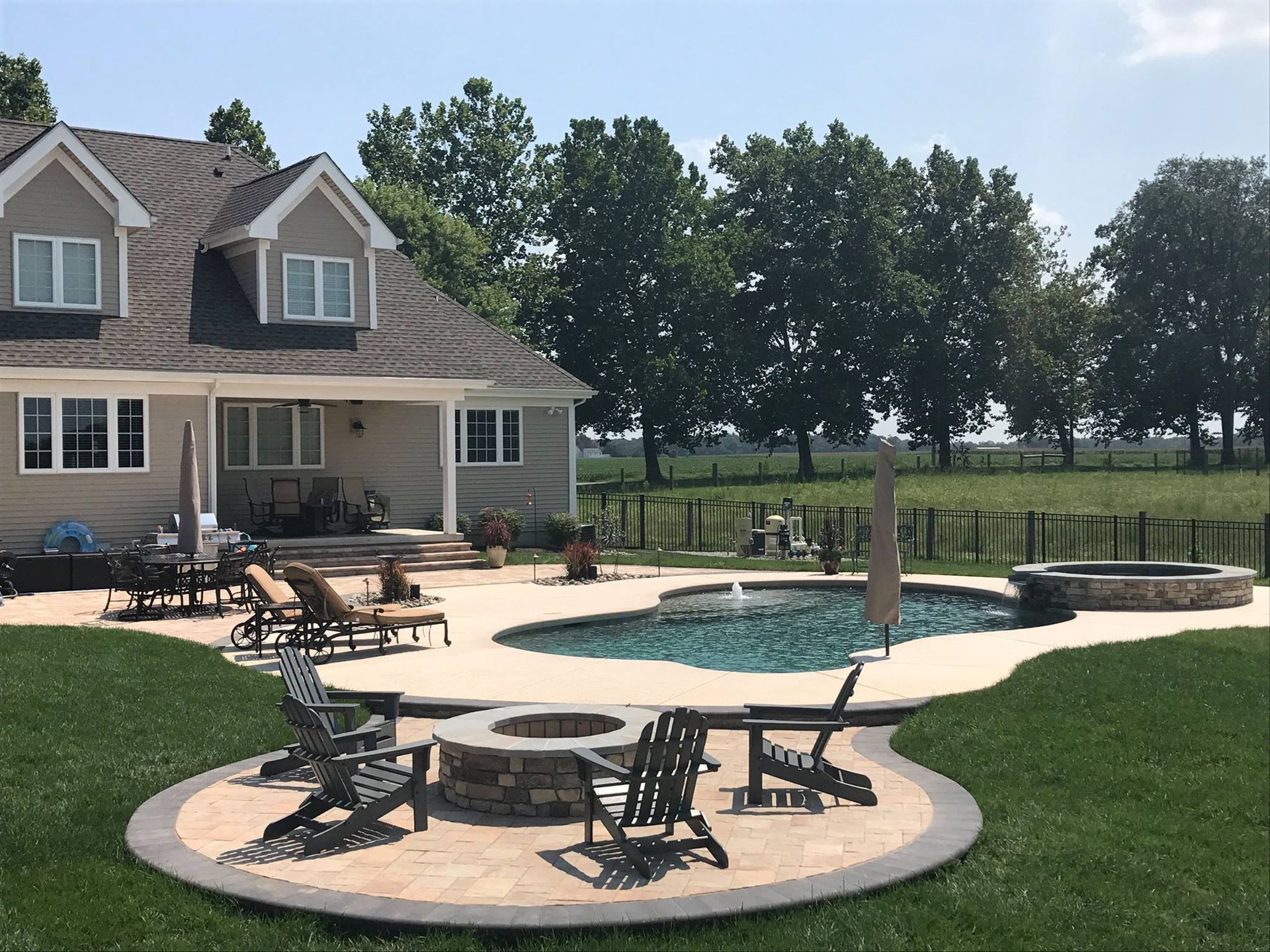 A large house with a swimming pool and a fire pit