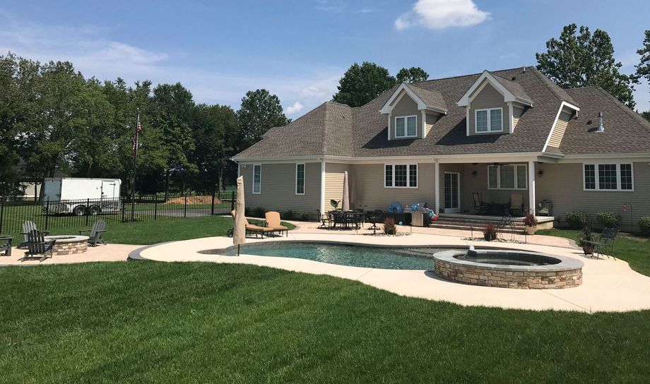 A large house with a swimming pool in the backyard