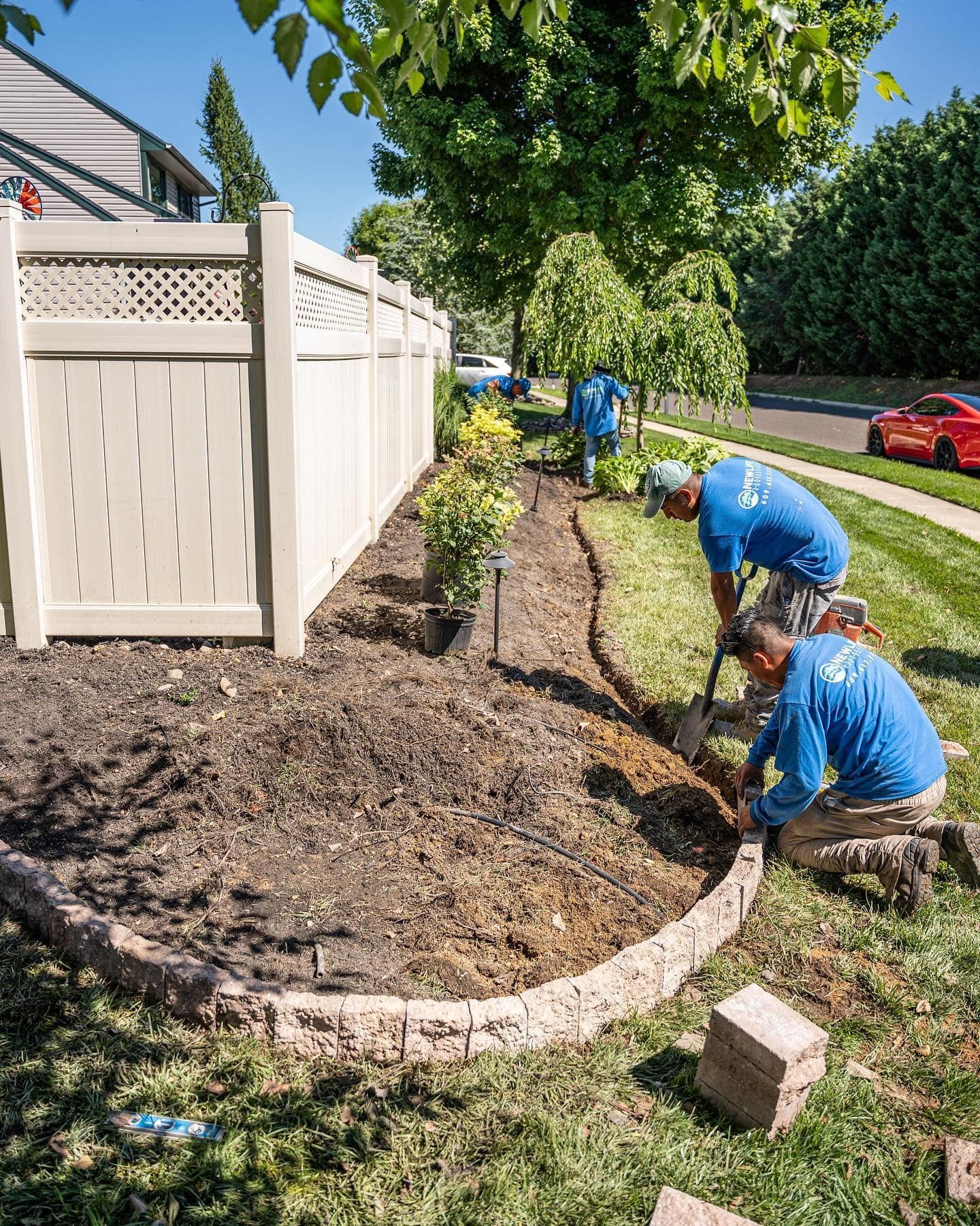 A group of men are working on a garden.