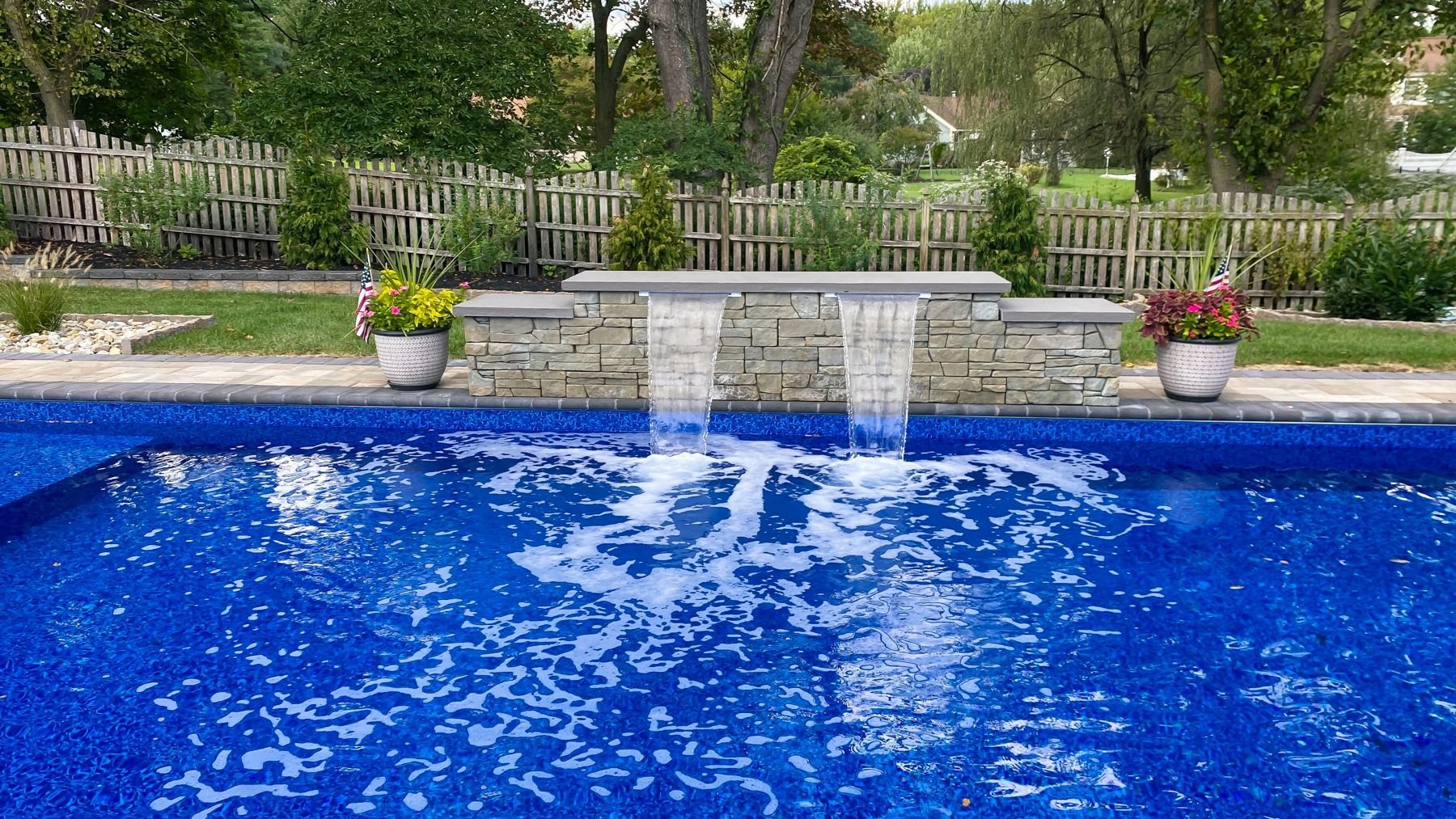 There is a waterfall in the middle of the pool.