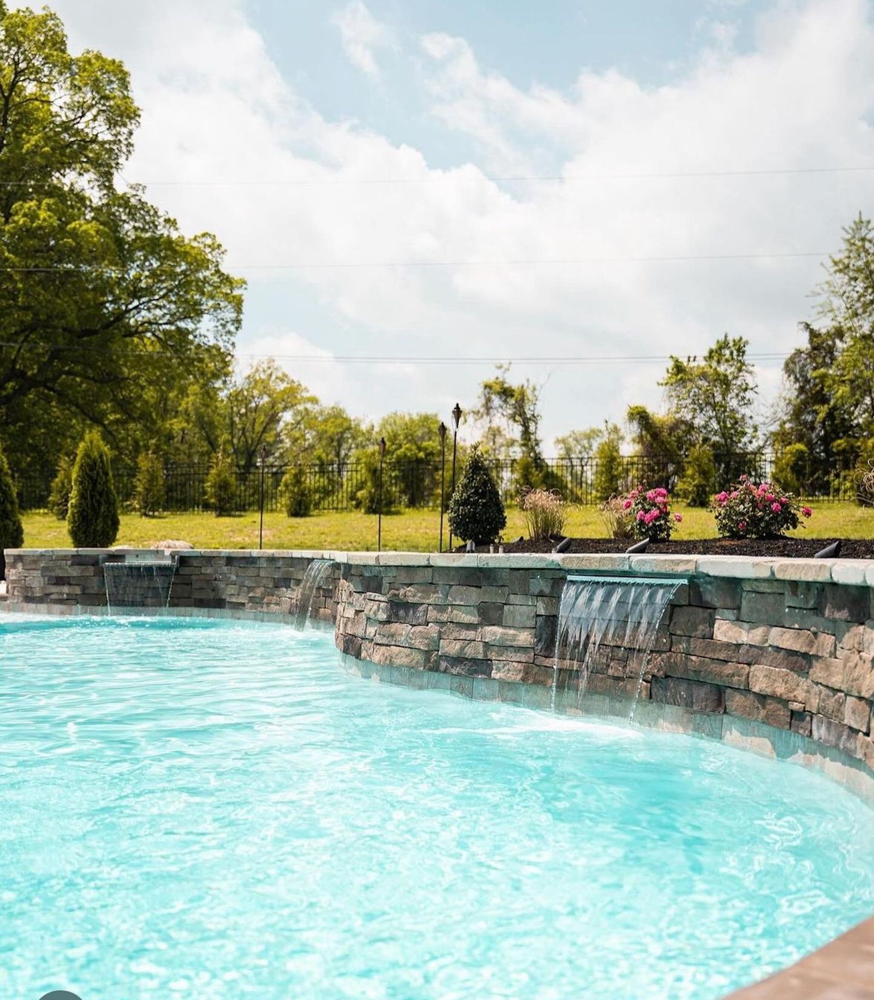 There is a waterfall in the middle of the pool.