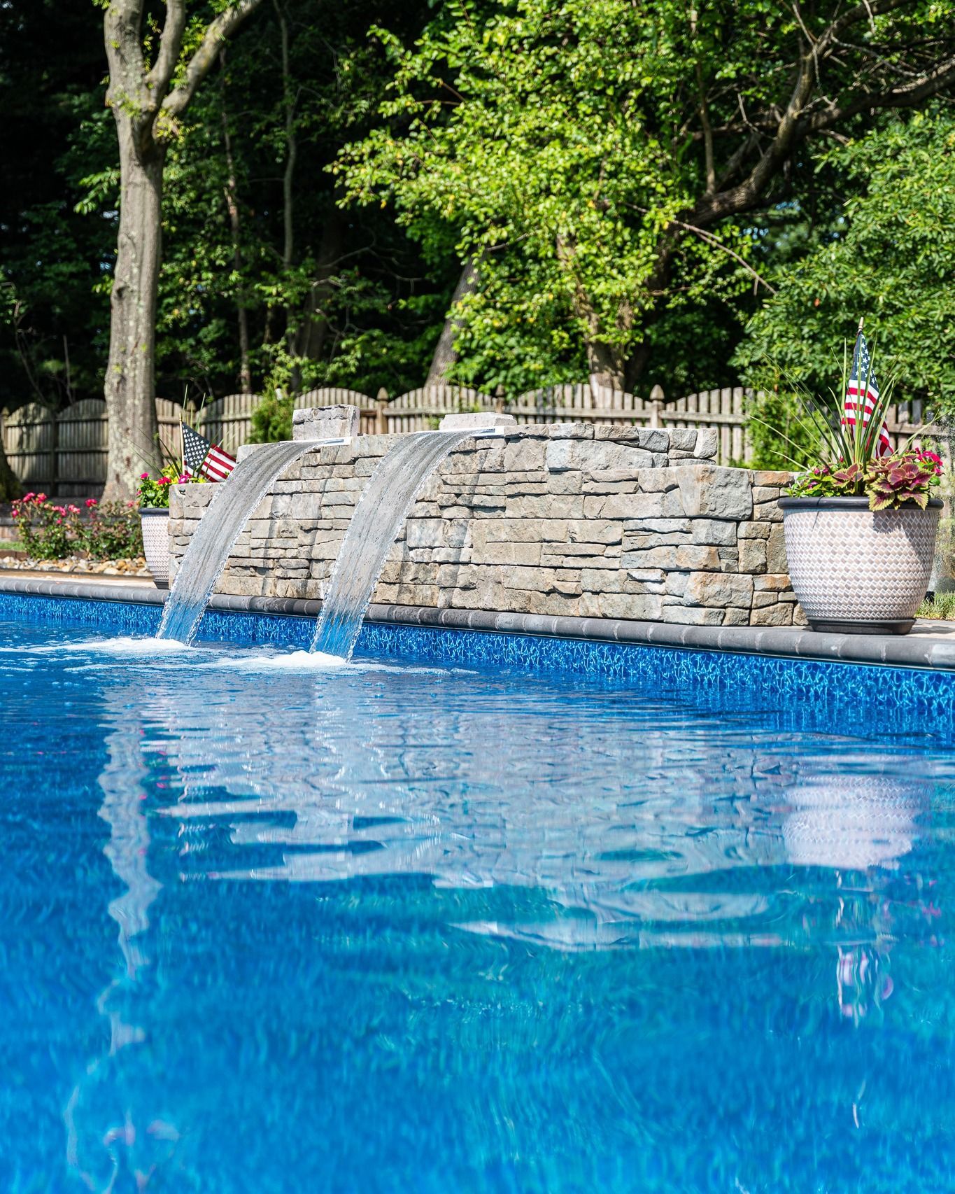 There is a waterfall in the middle of the pool.