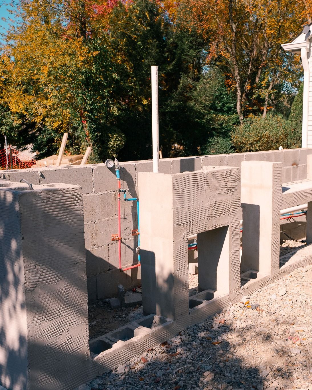 A concrete structure is being built with trees in the background