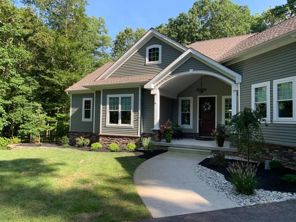 A house with a porch and a walkway leading to it