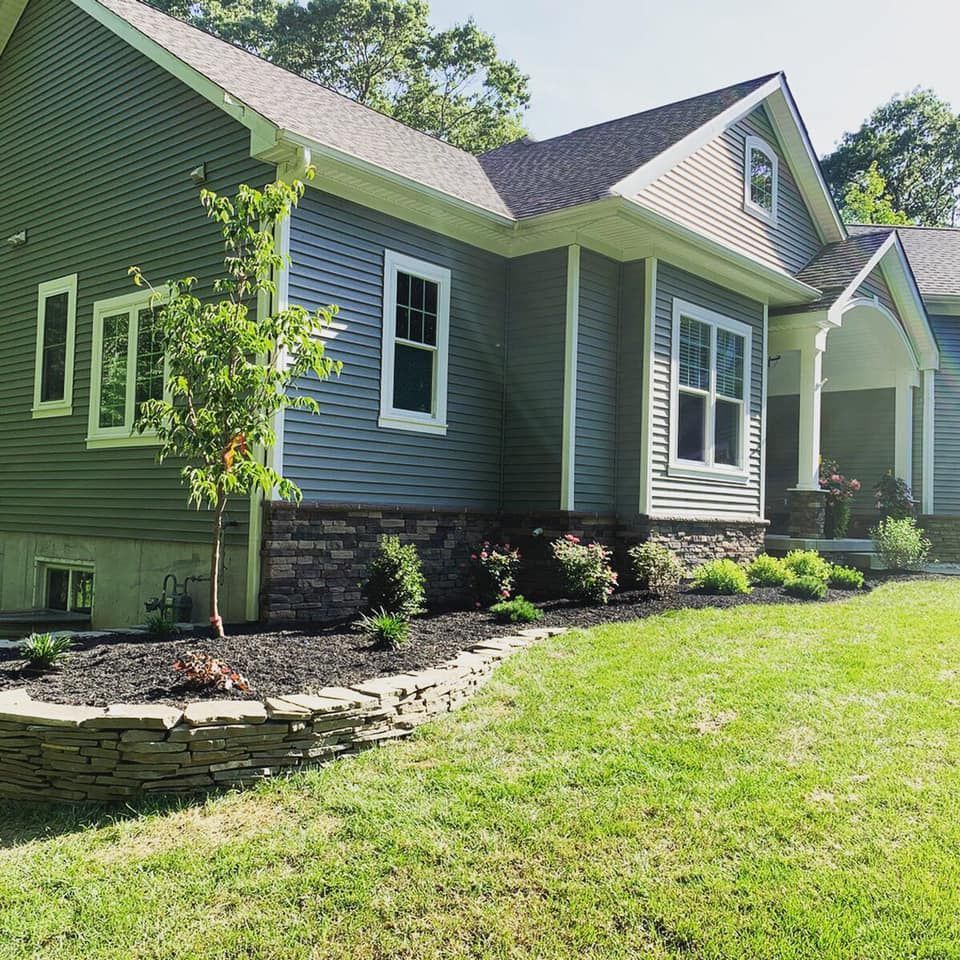 A house with a lush green lawn in front of it