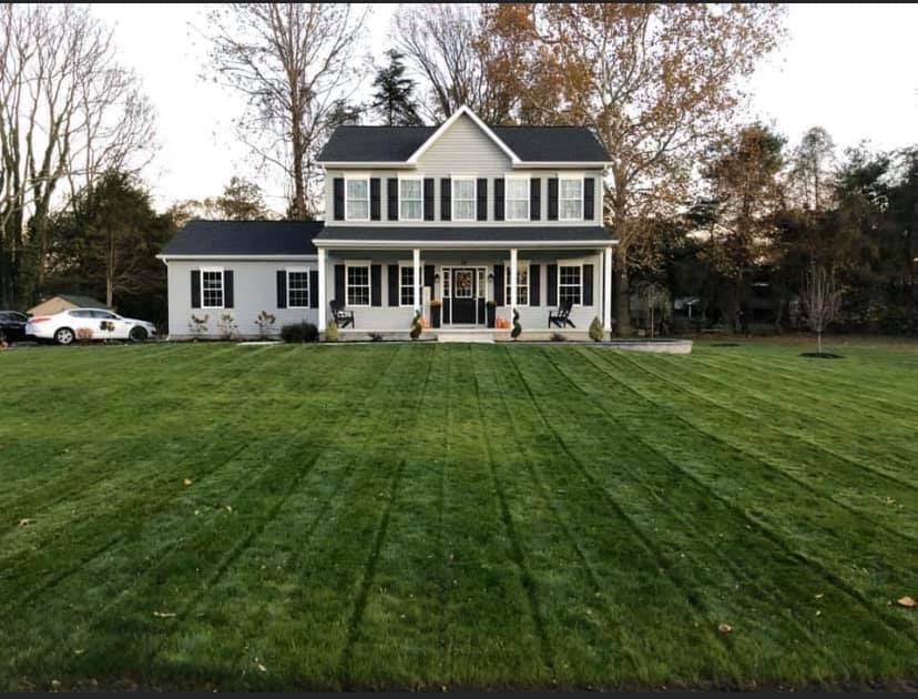 A large house with a lush green lawn in front of it