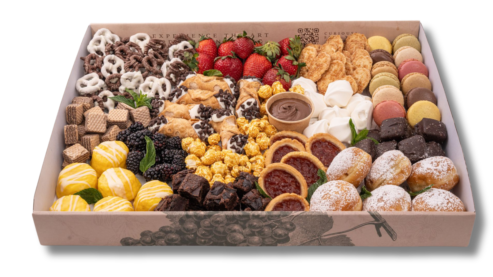 A box filled with a variety of desserts and fruit.