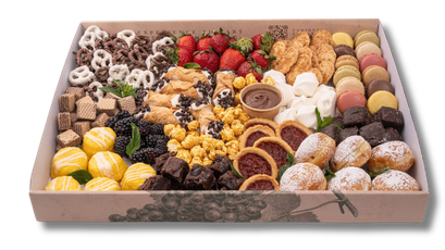 A box filled with a variety of desserts and fruit.