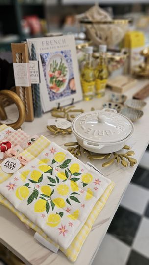 A wooden cutting board filled with food on a wooden stool.