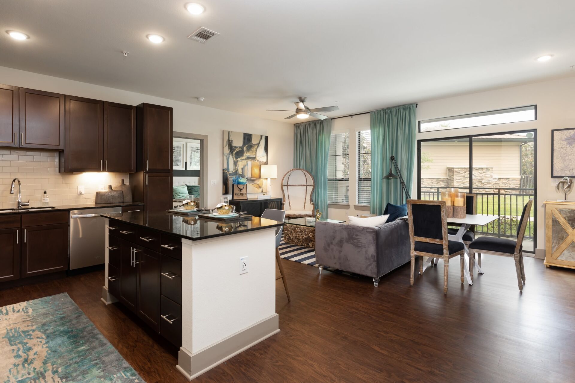 Equipped kitchen with kitchen island and living room view | Waterford Trails