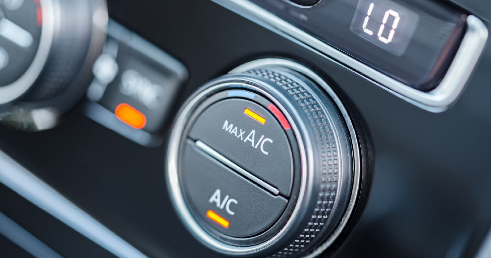 a close up of a car 's air conditioning control .