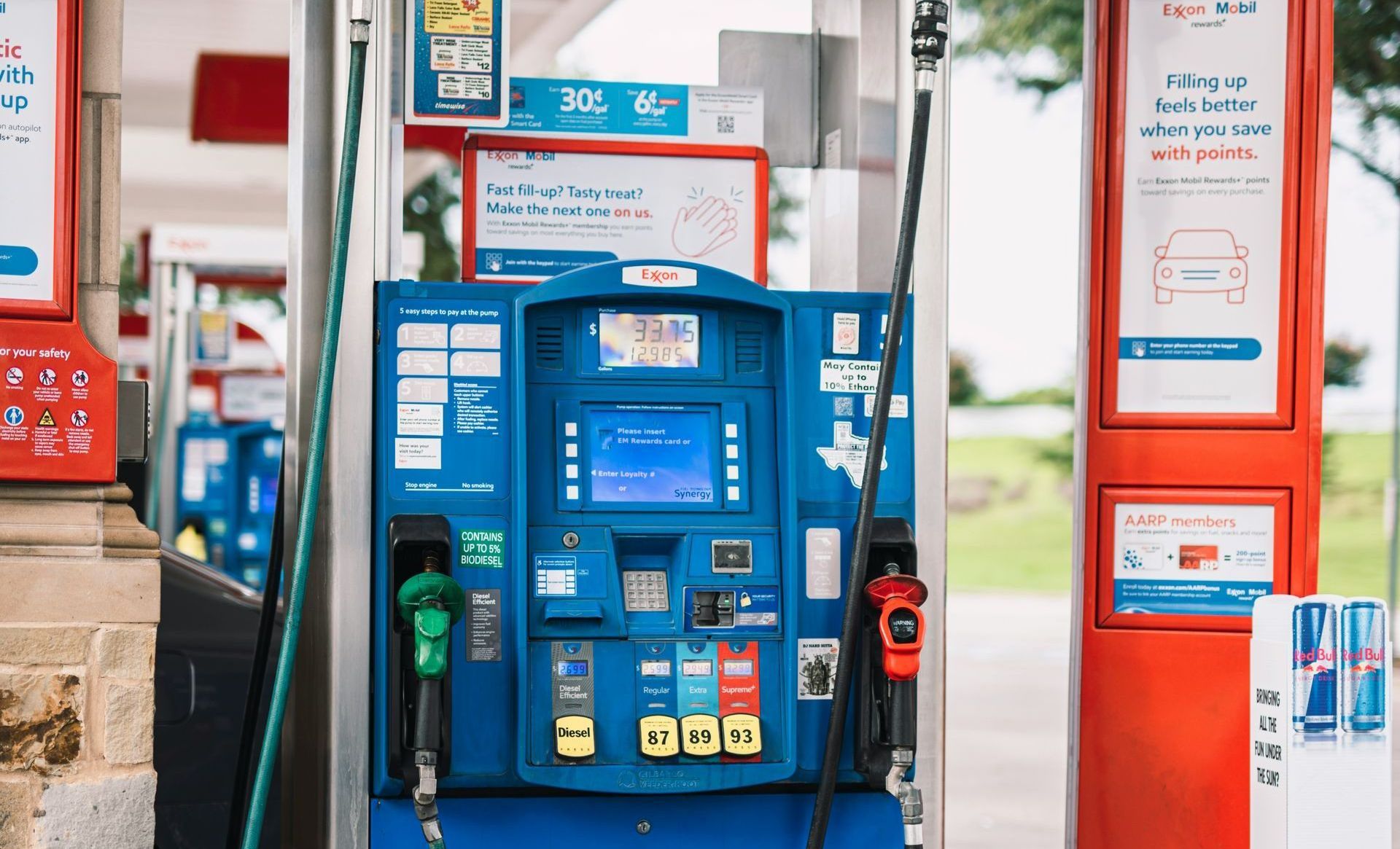 A gas pump at a gas station that says synergy on it