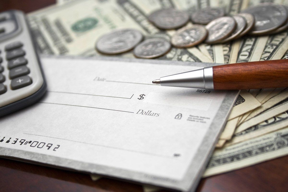 Closeup of Blank Check and Bills — Savannah, GA — Discount Check Casher