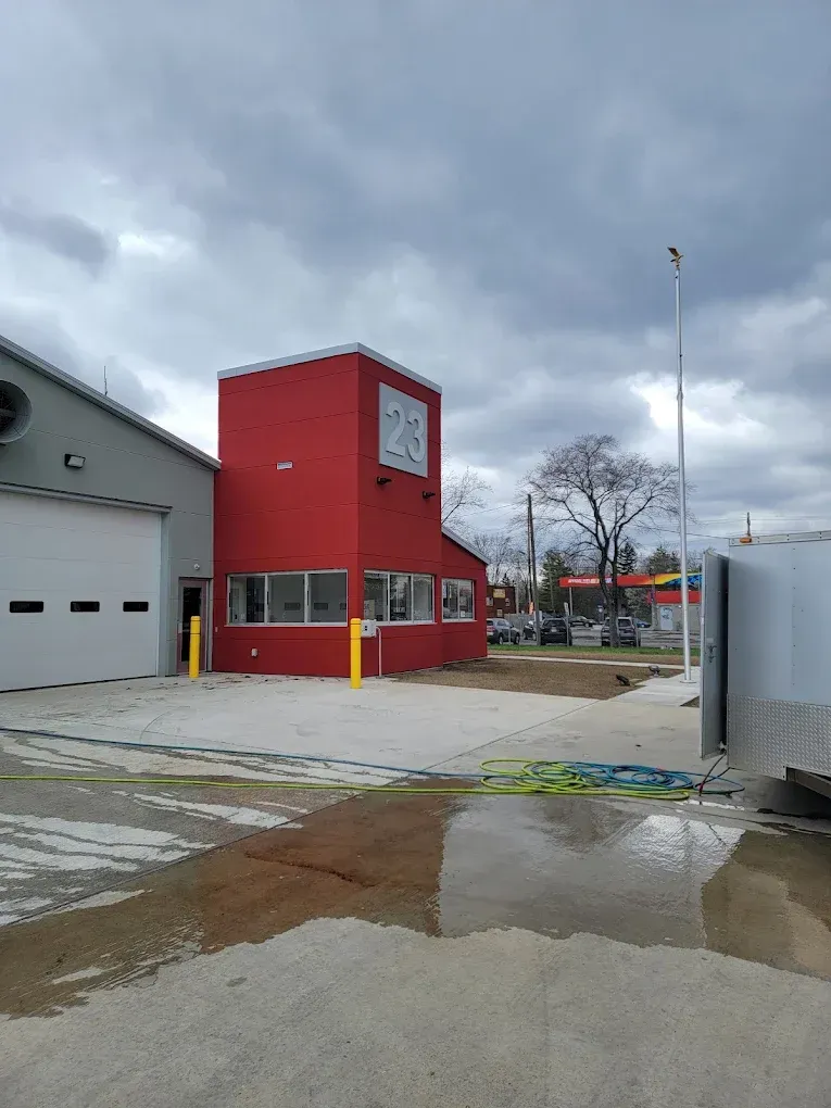 A red building with a clock on top of it