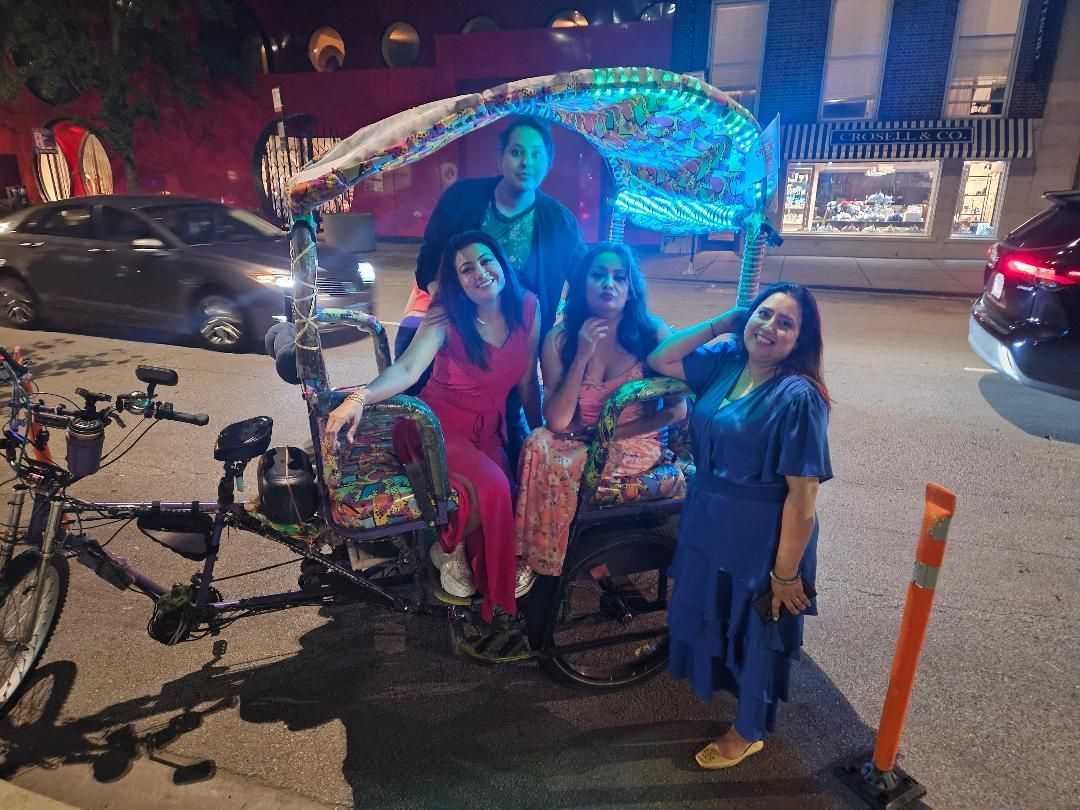 Four friends smiling for a photo after a memorable chicago rikshaw ride, a perfect group activity for those searching for pedicab tours near me.