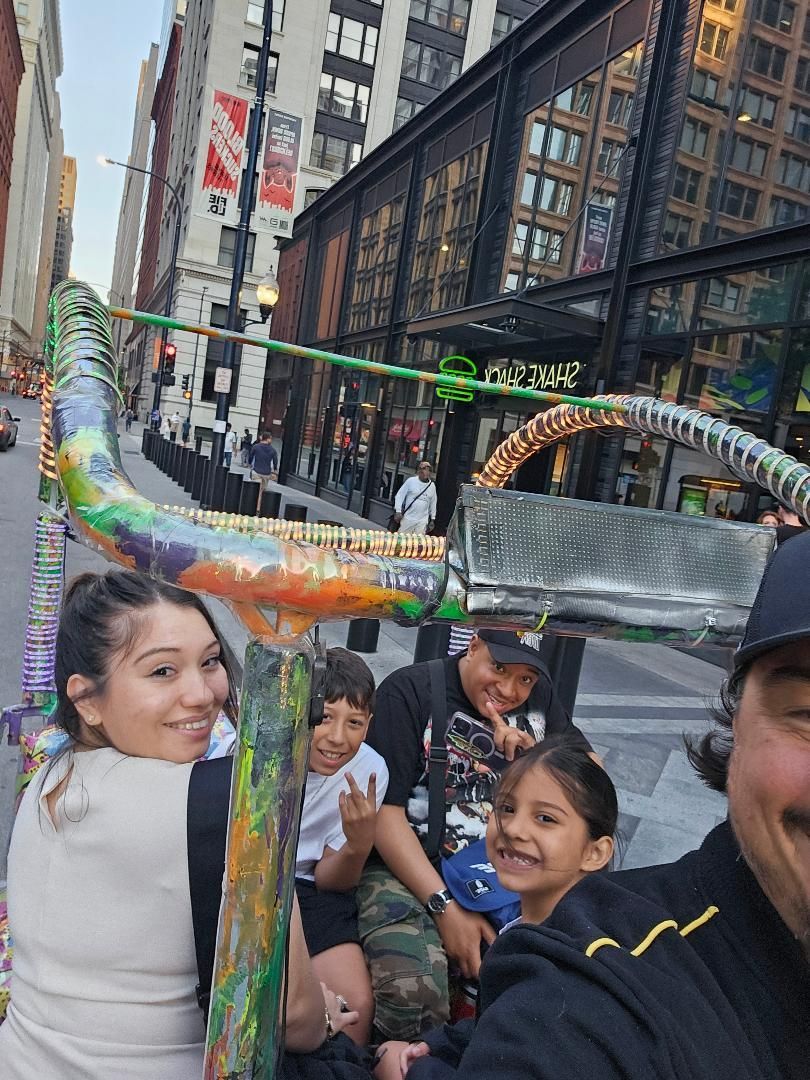 Our chicago pedicab tours are fun for the whole family, as this smiling group shows while enjoying their bike taxi chicago adventure downtown.