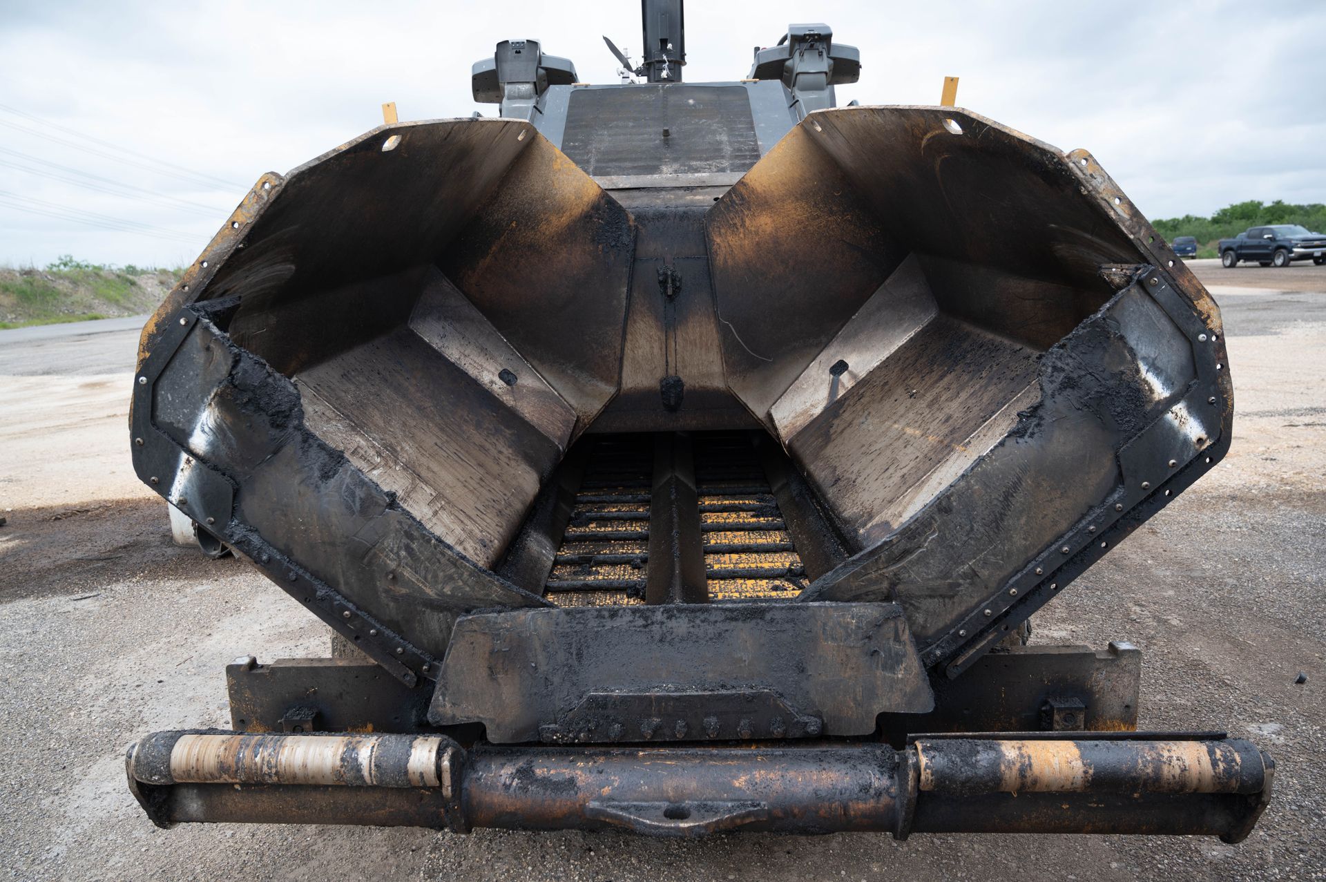 The back of an asphalt paving machine is shown