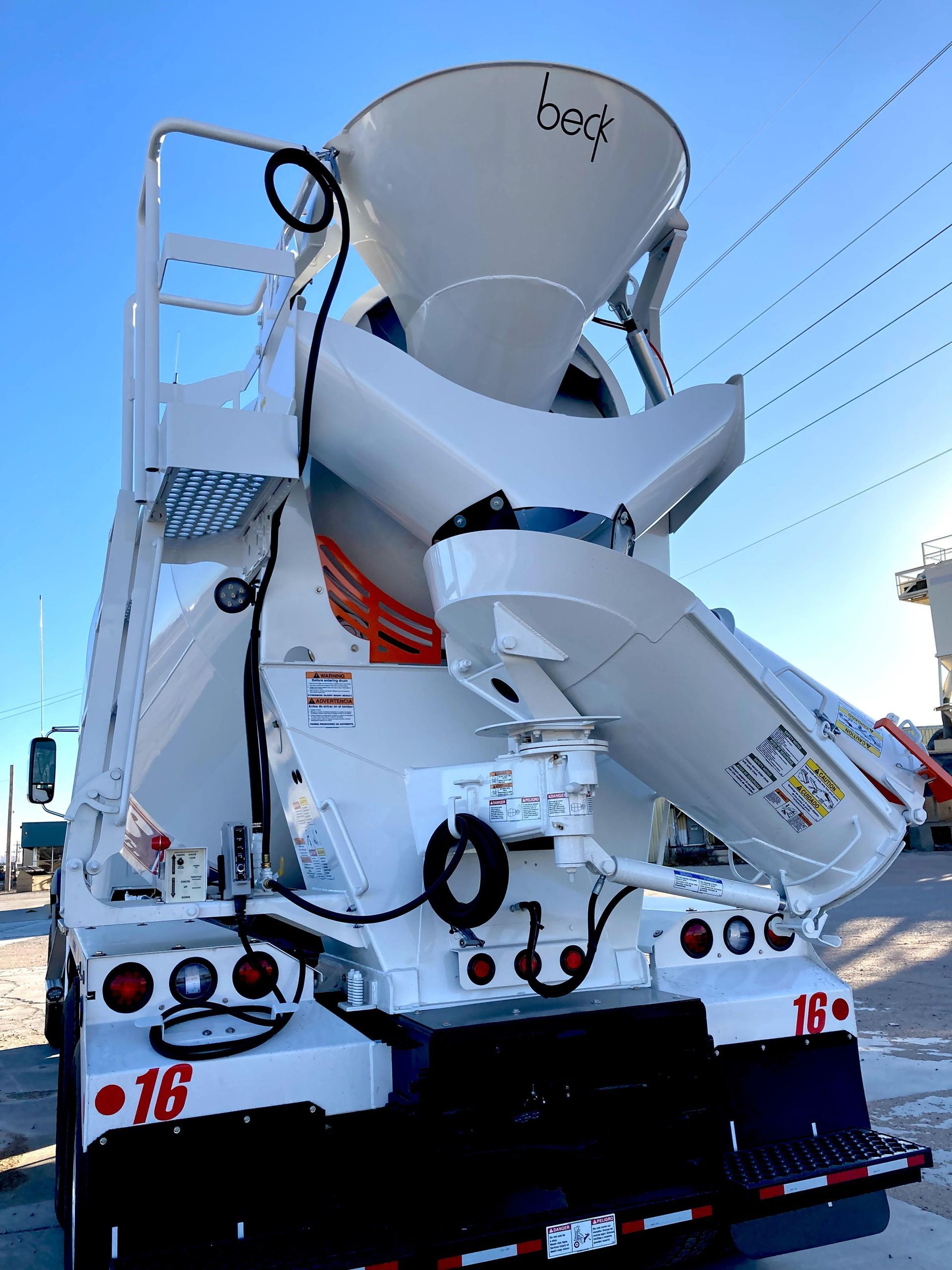 A concrete mixer truck with the number 16 on the back