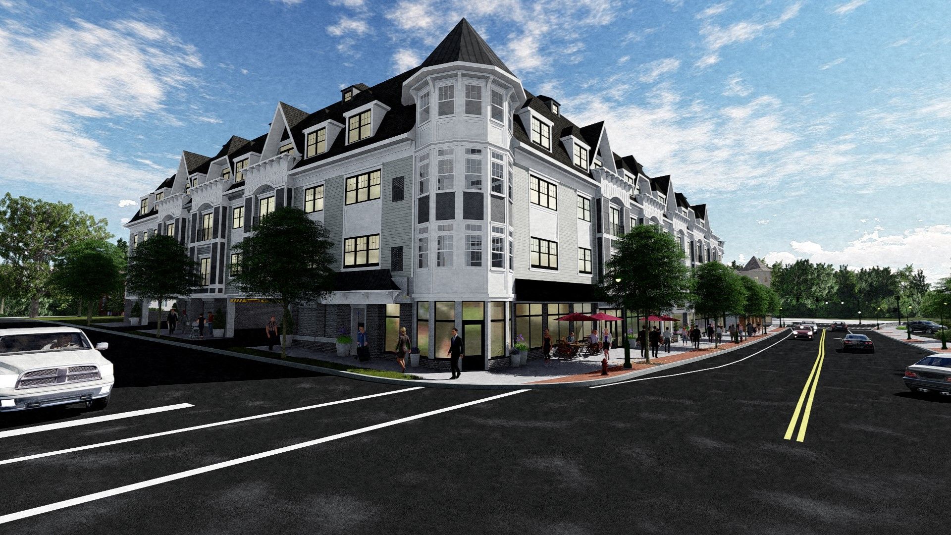 Building corner on a street with a café, cars, trees, and a blue sky.